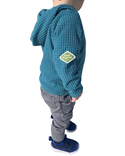 Kid wearing grid fleece outdoor hoodie from Squak Mountain Co.