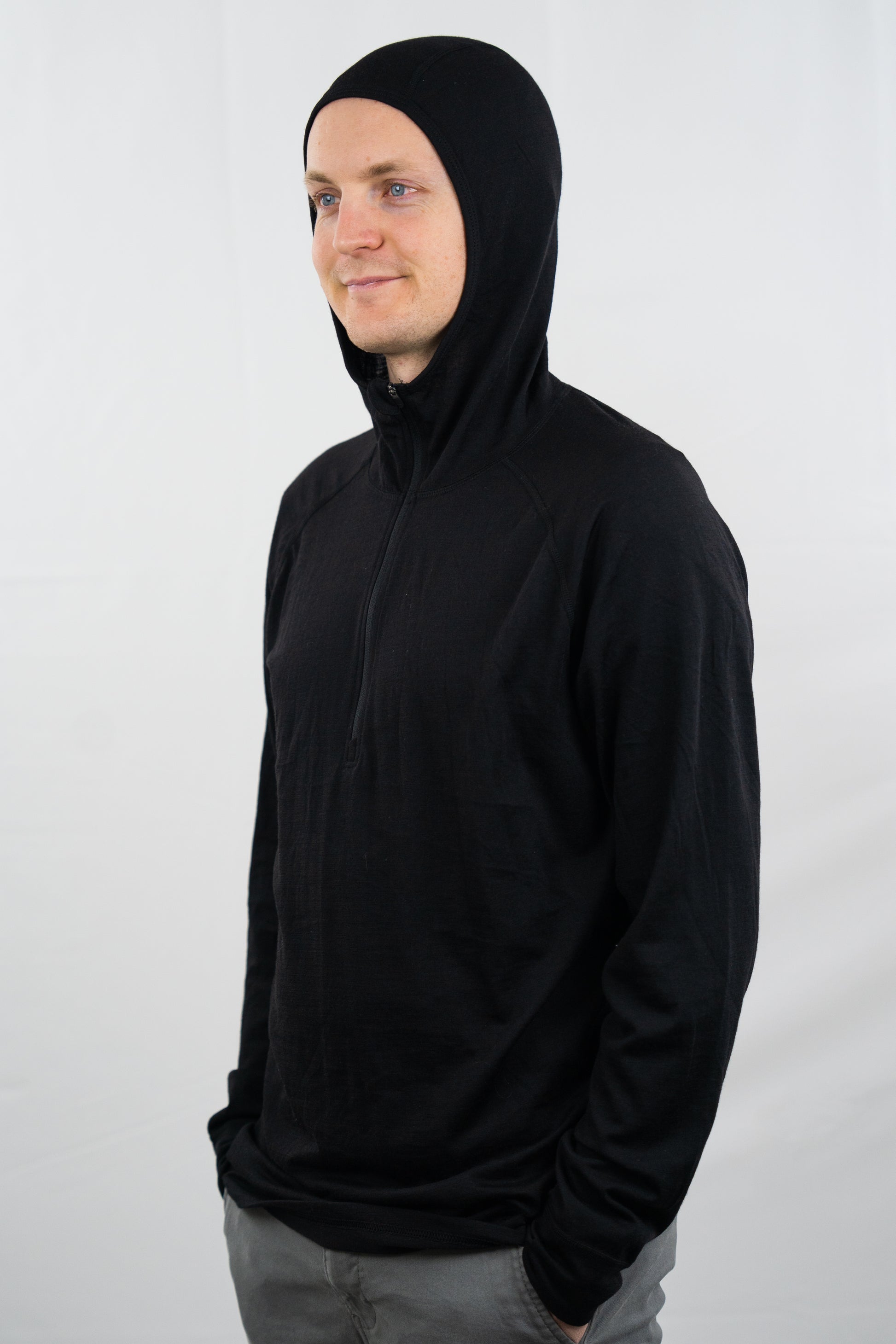 Person wearing black wool base layer hoodie with hood on from Squak Mountain Co.