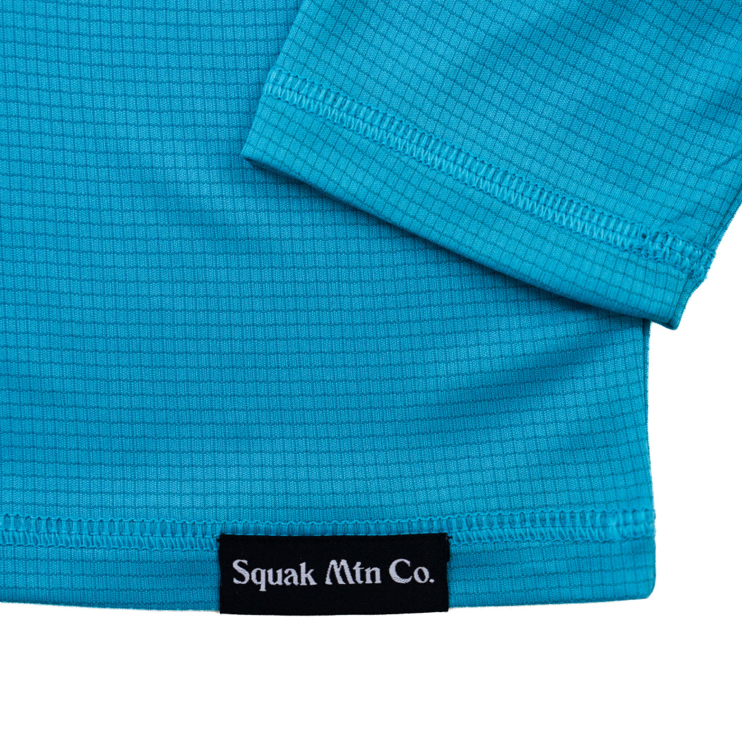 Logo on aqua blue outdoor sun hoodie from Squak Mountain Co.