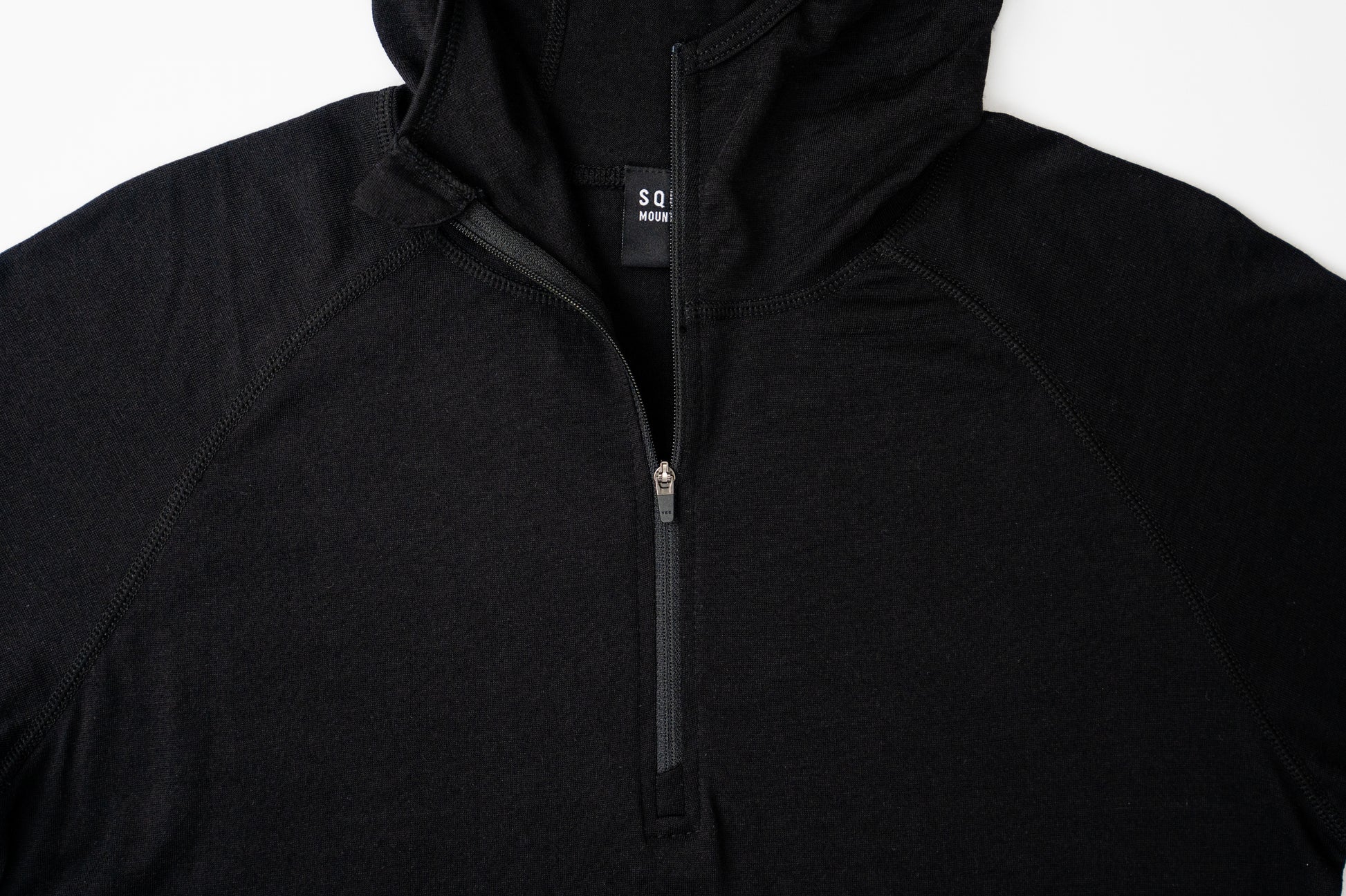 Top half of womens black wool base layer hoodie from Squak Mountain Co.