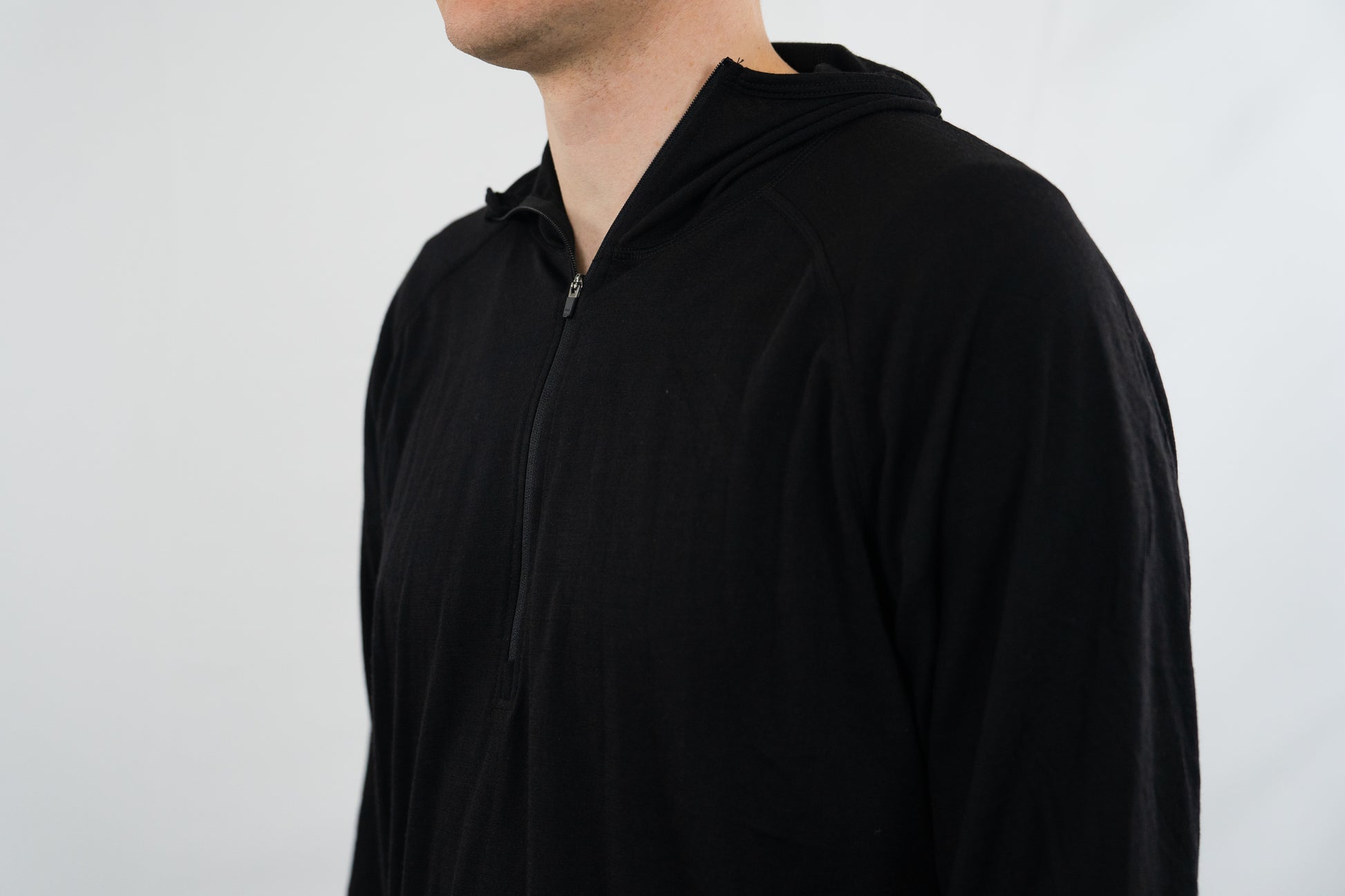 Person wearing black wool base layer hoodie from Squak Mountain Co.